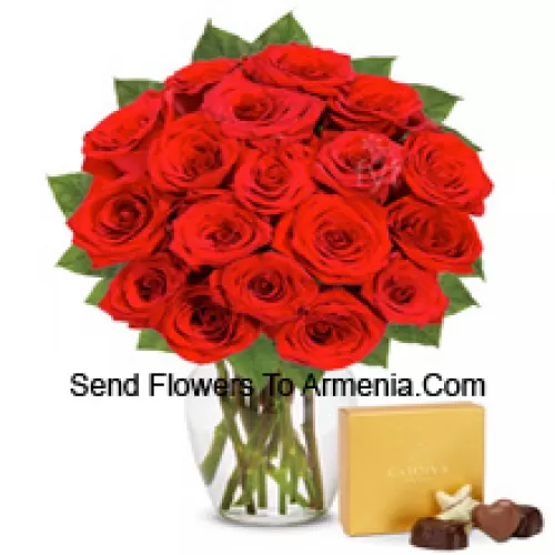 25 Red Roses With Some Ferns In A Glass Vase Accompanied With An Imported Box Of Chocolates