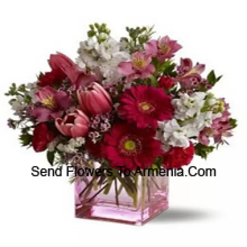 Red Roses, Red Tulips And Assorted Flowers With Seasonal Fillers Arranged Beautifully In A Glass Vase