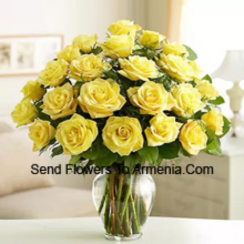 25 Yellow Roses With Some Ferns In A Glass Vase