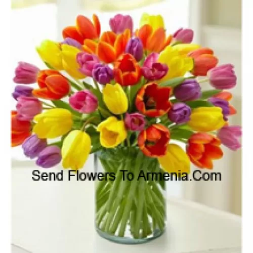 Mixed Colored Tulips In A Glass Vase - Please Note That In Case Of Non-Availability Of Certain Seasonal Flowers The Same Will Be Substituted With Other Flowers Of Same Value