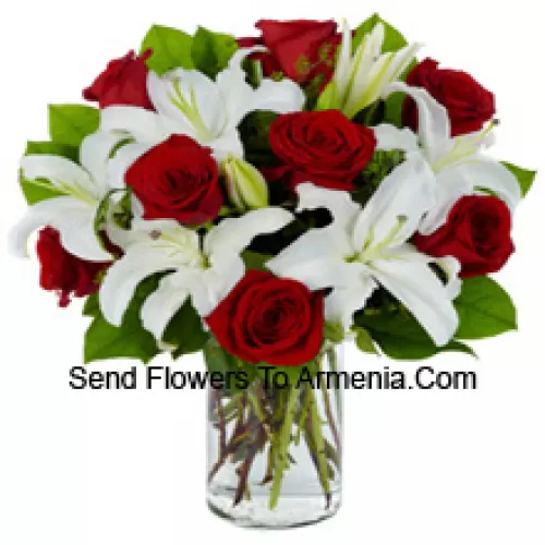 Red Roses And White Lilies With Seasonal Fillers In A Glass Vase