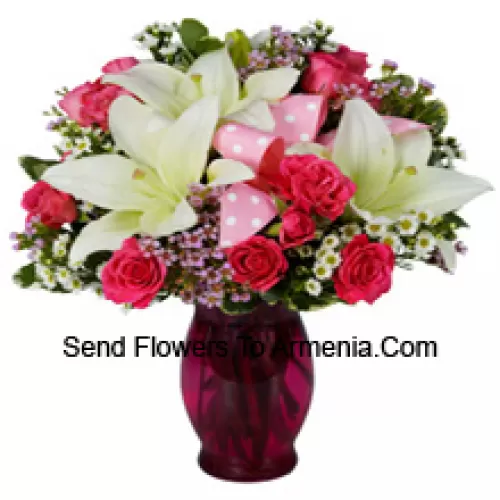 Pink Roses And White Lilies With Seasonal Fillers In A Glass Vase