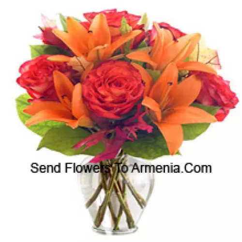 Orange Lilies And Orange Roses With Seasonal Fillers Arranged Beautifully In A Glass Vase