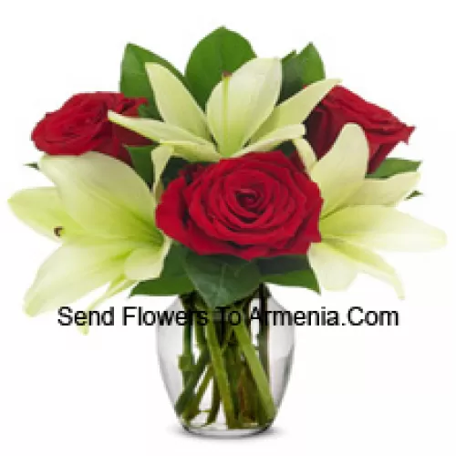 Red Roses And White Lilies With Seasonal Fillers In A Glass Vase