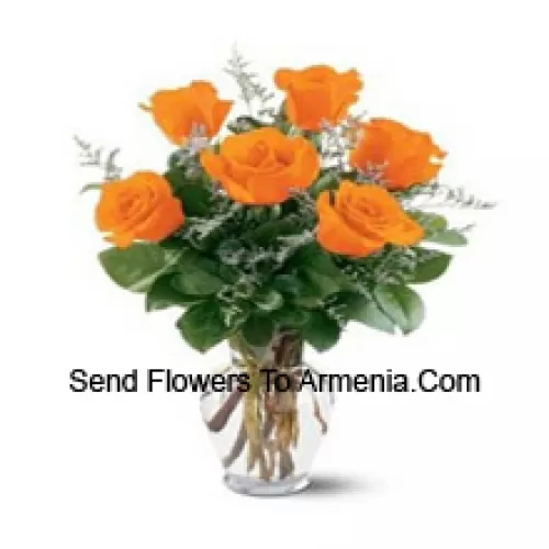 7 Yellow Roses With Some Ferns In A Glass Vase