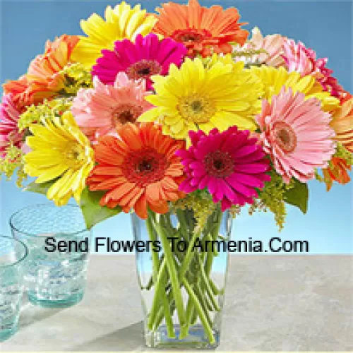 25 Mixed Colored Gerberas With Some Ferns In A Glass Vase