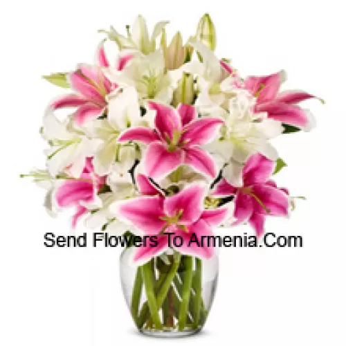 White And Pink Lilies With Some Ferns In A Glass Vase