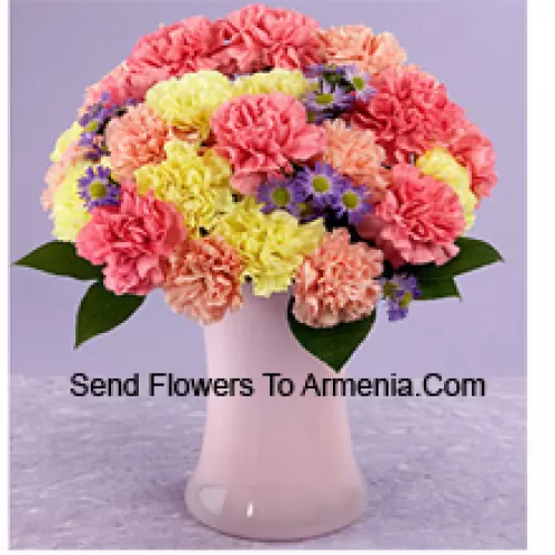 25 Mixed Colored Carnations With Seasonal Fillers In A Glass Vase