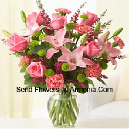 Pink Roses, Pink Carnations And Pink Lilies With Assorted Ferns And Fillers In A Glass Vase