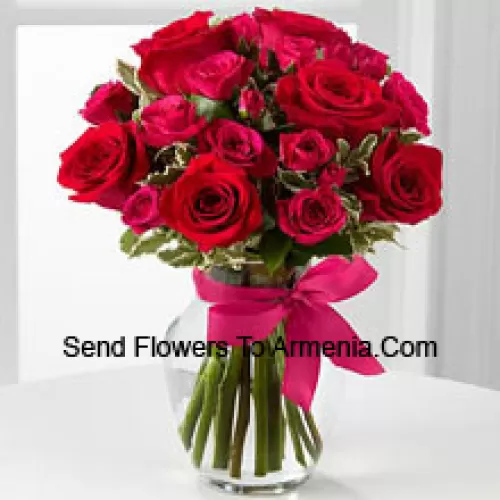 19 Red Roses With Seasonal Fillers In A Glass Vase Decorated With A Pink Bow