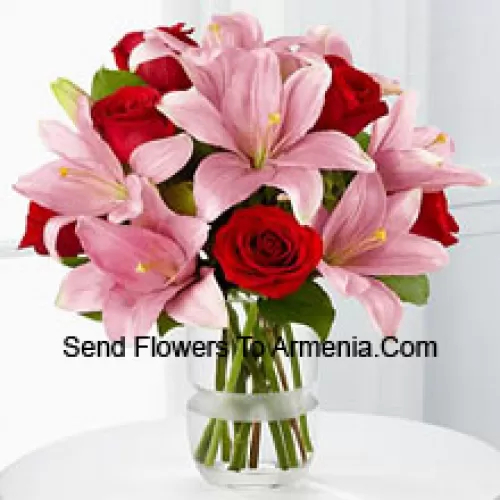 Red Roses And Pink Lilies With Seasonal Fillers In A Glass Vase