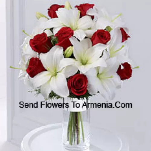 This product is a sleek and elegant way to spread goodwill for the holiday season. Red roses are set to catch the eye arranged amongst white Oriental lilies in a clear glass cylinder vase wrapped in silver ribbon to create a seasonal display of heartfelt wishes for a magical holiday. (Please Note That We Reserve The Right To Substitute Any Product With A Suitable Product Of Equal Value In Case Of Non-Availability Of A Certain Product)