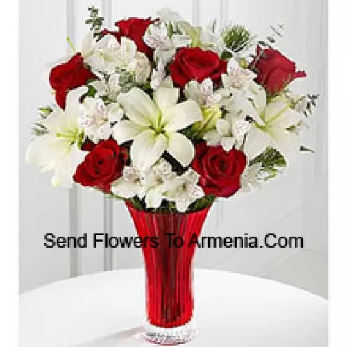 This Bouquet is a gorgeous expression of yuletide joy and elegance. Red roses pop against a background of white Asiatic lilies and Peruvian lilies lovingly arranged in a red designer glass vase to create a bouquet of seasonal celebration. (Please Note That We Reserve The Right To Substitute Any Product With A Suitable Product Of Equal Value In Case Of Non-Availability Of A Certain Product)