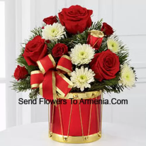 A blossoming display of seasonal merriment and festive greetings. Rich red roses and spray roses sweetly mingle with white chrysanthemums arranged amongst lush holiday greens, all perfectly accented with drum pics and a gold-edged red ribbon. Arriving in a designer red and gold drum inspired vase, this bouquet will express your most heartfelt wishes for a wonderful holiday season. (Please Note That We Reserve The Right To Substitute Any Product With A Suitable Product Of Equal Value In Case Of Non-Availability Of A Certain Product)