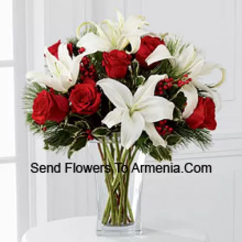 Fulfill their dreams for a glimpse of the season's inspired beauty. Rich red roses dazzle and delight when arranged with snowy white Oriental lilies accented with assorted holiday greens and variegated holly stems in a clear, sculpted glass vase. This bouquet offers them a warm wish for a lovely holiday season they will always hold dear. (Please Note That We Reserve The Right To Substitute Any Product With A Suitable Product Of Equal Value In Case Of Non-Availability Of A Certain Product)