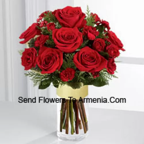 Send them the warmth and heartfelt sentiments expressed throughout the holiday season. Rich red roses and spray roses are offset by burgundy mini carnations, variegated holly stems and assorted holiday greens, beautifully arranged in a clear glass gold banded vase to bring your special recipient a merry moment they will treasure throughout the Christmas season. (Please Note That We Reserve The Right To Substitute Any Product With A Suitable Product Of Equal Value In Case Of Non-Availability Of A Certain Product)