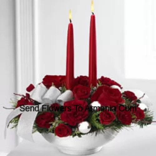 Our Holiday Elegance Centerpiece will add that special spark to their seasonal celebration with its vibrant array of crimson blooms! Red roses, carnations and spray roses sit amongst holiday greens in a posh ceramic silver container adorned with a beautiful silver ribbon accent and two taper candles to bring a holiday glow of warmth and peace to their table. (Please Note That We Reserve The Right To Substitute Any Product With A Suitable Product Of Equal Value In Case Of Non-Availability Of A Certain Product)