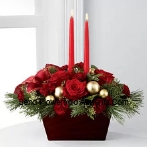 An exquisite display of holiday beauty to add warmth and cheer to their special celebrations. Rich red roses and burgundy mini carnations are set to impress surrounded by lush holiday greens, seeded eucalyptus, gold glass balls and a gold-edged red ribbon arranged elegantly around two red taper candles. Presented in a chocolate brown bamboo container, this centerpiece will usher in joy and goodwill with each treasured bloom (Please Note That We Reserve The Right To Substitute Any Product With A Suitable Product Of Equal Value In Case Of Non-Availability Of A Certain Product)