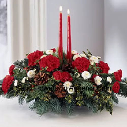 Share the joy this season with a festive fresh arrangement of red carnations and white pompons, winter greens and pinecones. Two red taper candles add seasonal charm to this centerpiece. (Please Note That We Reserve The Right To Substitute Any Product With A Suitable Product Of Equal Value In Case Of Non-Availability Of A Certain Product)